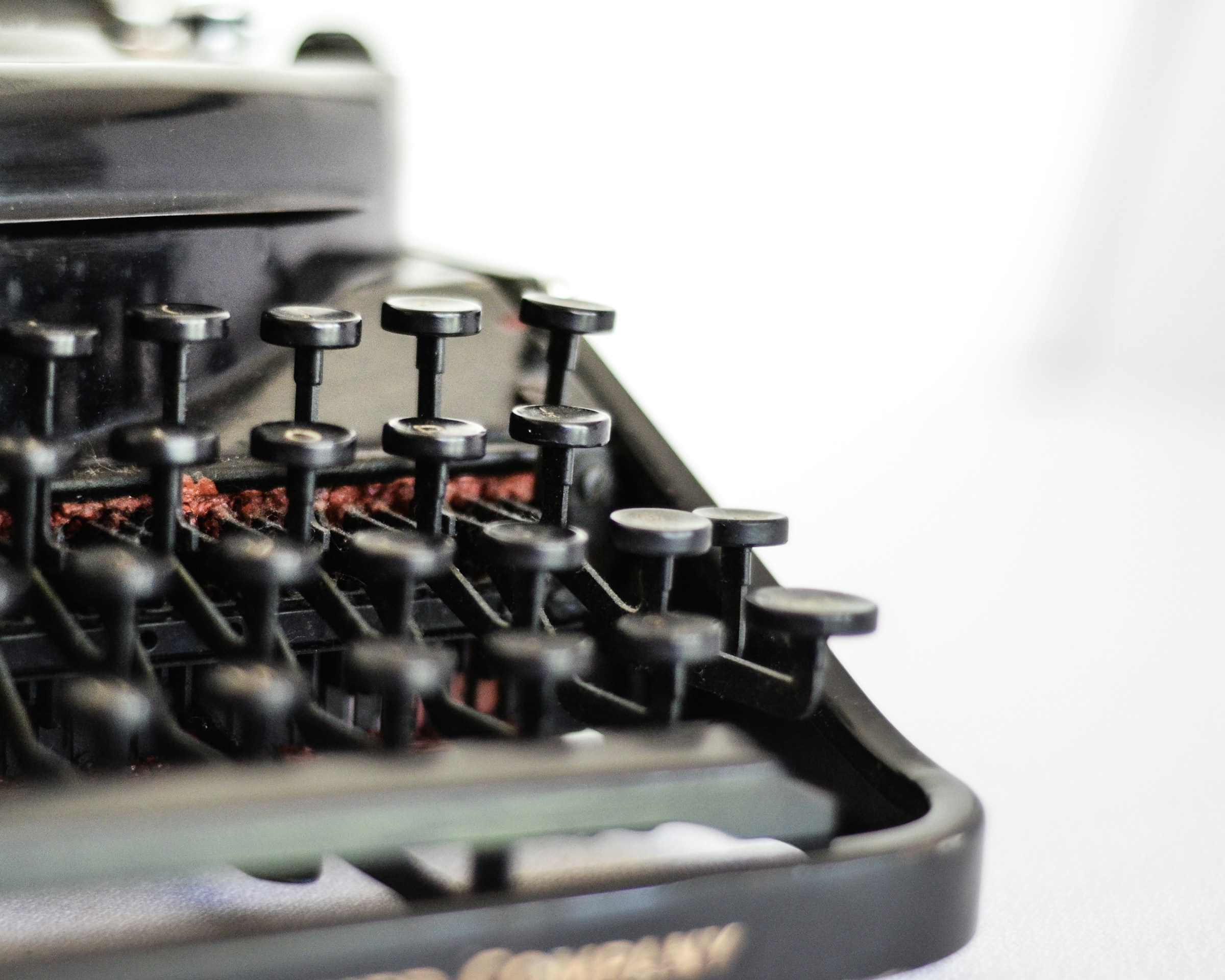 A close up on the front corner of an old typewriter.