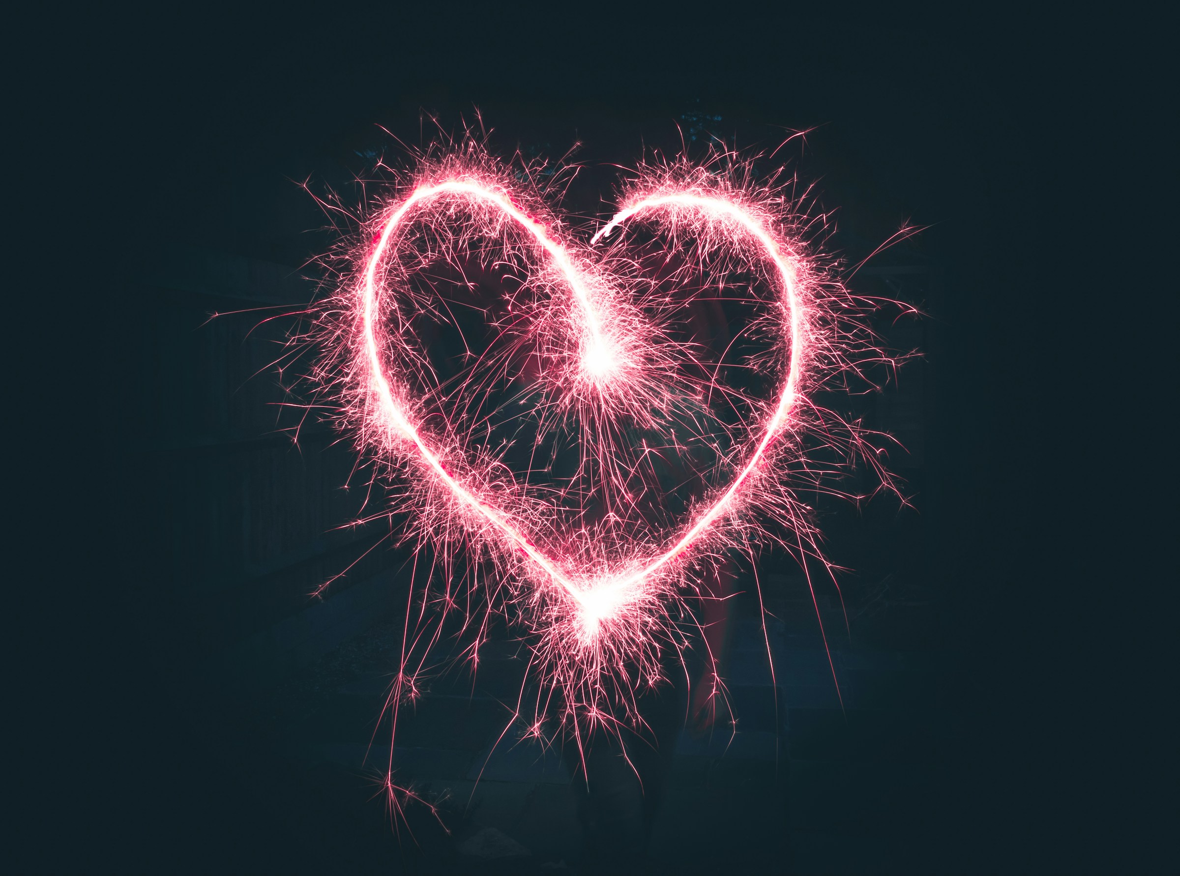 A pink heart made of fireworks.